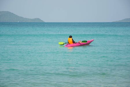 men paddle kayak on the sea on islandのeditorial素材