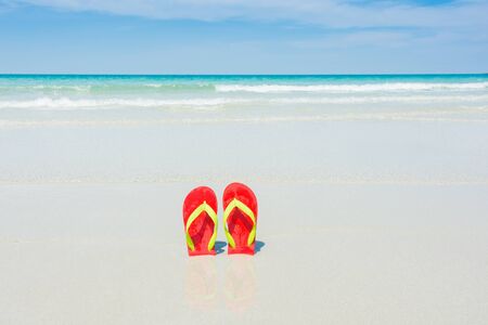 Beach, slippers on tropical beach in holiday at Thailandの写真素材