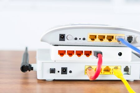 Wireless modem router network hub with cable connect on wooden table in the roomの写真素材