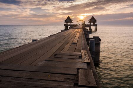 Twilight wood bridge tourist attraction at Djittabhawan Temple Pattaya of Thailandの写真素材