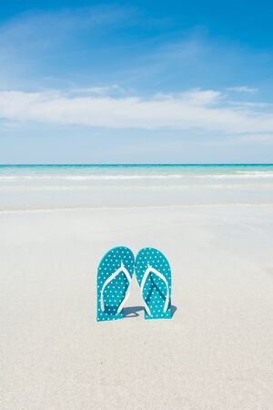 Beach, slippers on tropical beach in holiday at Thailandの写真素材