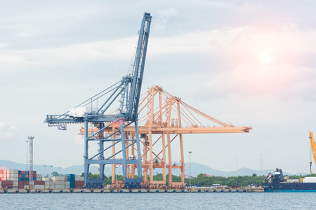 Industrial Container Cargo freight ship with working crane bridgeの写真素材