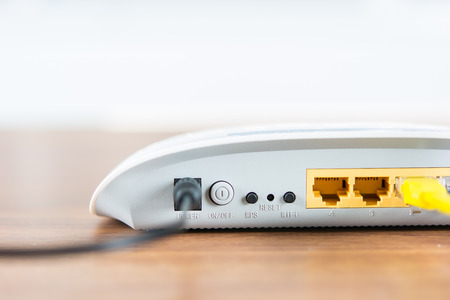 Wireless modem router network hub with cable connect on wooden table in the roomの写真素材