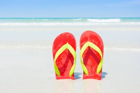 Beach, slippers on tropical beach in holiday at Thailandの写真素材