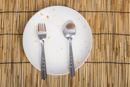 Empty Dirty bowl after food on table with wooden backgroundの写真素材