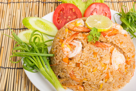 Special shrimp fried rice on white dish on wooden backgroundの写真素材