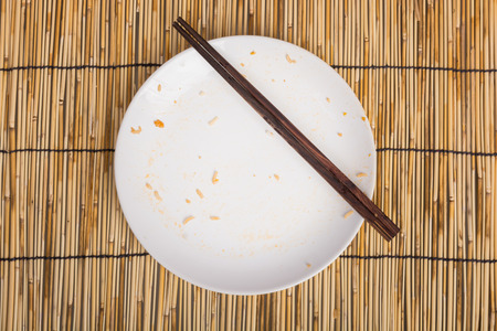 Empty Dirty bowl after food on table with wooden backgroundの写真素材