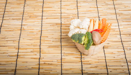 Vegetables full the basket on wooden backgroundの写真素材