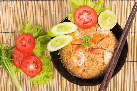 Special Shrimp fried rice in black cup on table with wooden backgroundの写真素材