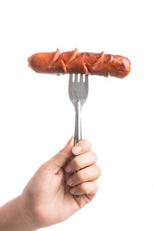 Grilled Sausage on fork isolated on over white backgroundの写真素材