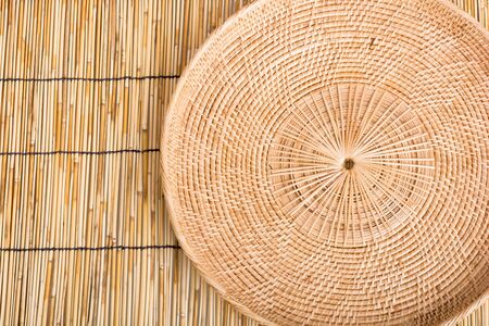 Empty rattan basket or tray on wooden table backgroundの写真素材
