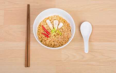 Hot and spicy instant noodle on wooden backgroundの写真素材