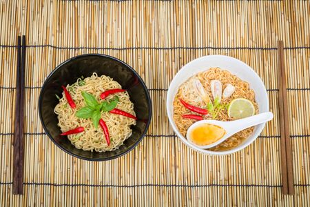 Hot and spicy instant noodle on wooden backgroundの写真素材
