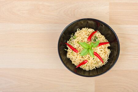 Hot and spicy instant noodle on wooden backgroundの写真素材
