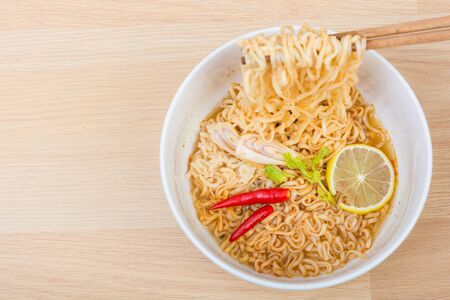Hot and spicy lap instant noodle on wooden backgroundの写真素材