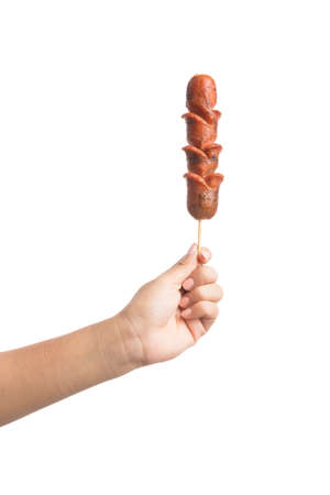 Grilled Sausage on fork isolated on over white backgroundの写真素材