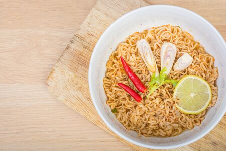 Hot and spicy instant noodle on wooden backgroundの写真素材