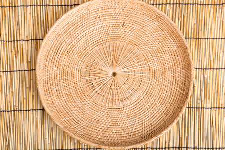 Empty rattan basket or tray on wooden table backgroundの写真素材