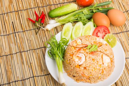 Special shrimp fried rice on white dish on wooden backgroundの写真素材