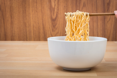 Hot and spicy lap instant noodle on wooden backgroundの写真素材