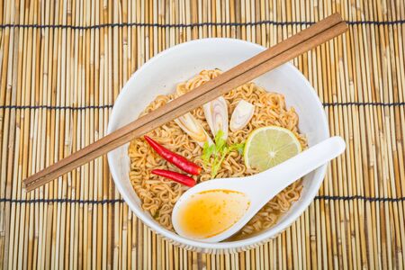 Hot and spicy instant noodle on wooden backgroundの写真素材