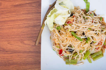 green papaya spicy salad Thai style on wooden background