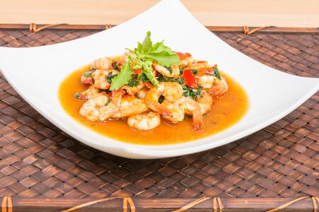 Thai food, Basil Shrimp Fried on wood table with wooden backgroundの写真素材