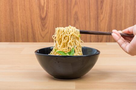 Hot and spicy lap instant noodle on wooden backgroundの写真素材