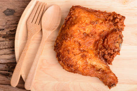 Fried chicken in wood dish on wooden table with backgroundの写真素材