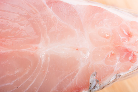 Piece of tilapia fish meat on wooden backgroundの写真素材