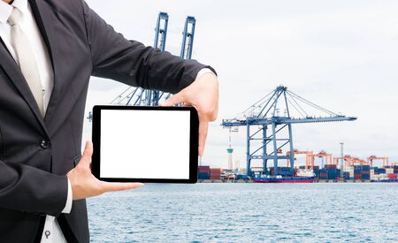 Engineering working hold tablet in front of cargo loading workplaceの写真素材