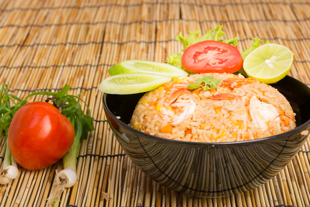 Special Shrimp fried rice in black cup on table with wooden backgroundの写真素材