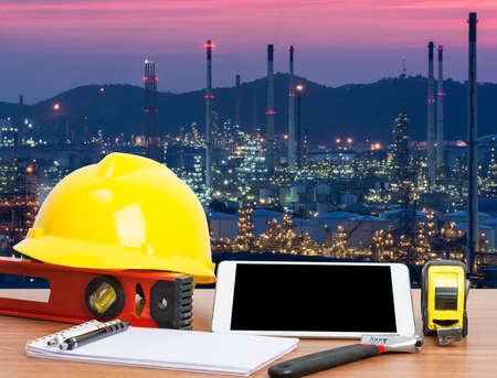 Working table engineer with tablet and tools in oil refinery industry business plantの写真素材