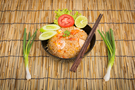Special Shrimp fried rice in black cup on table with wooden backgroundの写真素材