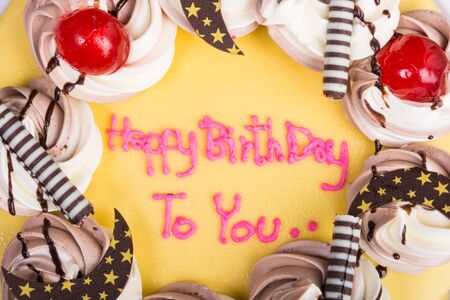 birthday chocolate cake topped with banana on wooden table