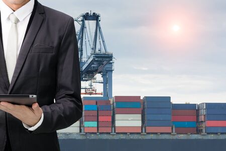 Engineering working hold tablet in front of cargo loading workplaceの写真素材