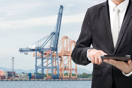 Engineering working hold tablet in front of cargo loading workplaceの写真素材