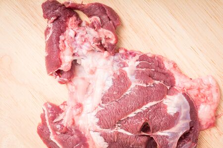 fresh raw beef meat slices on wooden for cooking on wood tableの写真素材