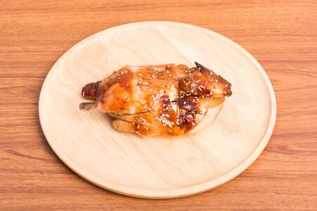 Whole roasted chicken dish wood on wooden tableの写真素材