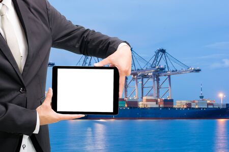 Engineering working hold tablet in front of cargo loading workplaceの写真素材