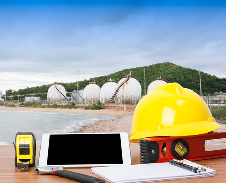Working table engineer with tablet and tools in oil refinery industry business plantの写真素材