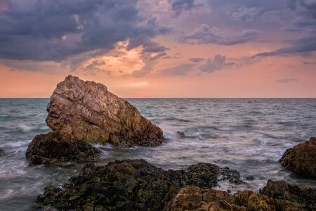 Seascape at the sea with stone during sunsetの写真素材