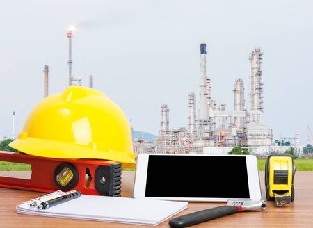 Working table engineer with tablet and tools in oil refinery industry business plantの写真素材
