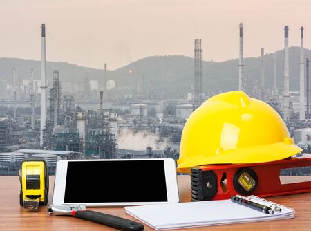 Working table engineer with tablet and tools in oil refinery industry business plantの写真素材