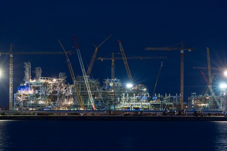Industrial landscape with cranes on the sunset blue backgroundのeditorial素材