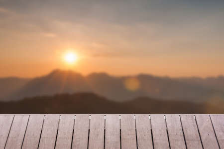 Wood table top on Majestic sunset in the mountains landscape background can put or montage your productsの写真素材