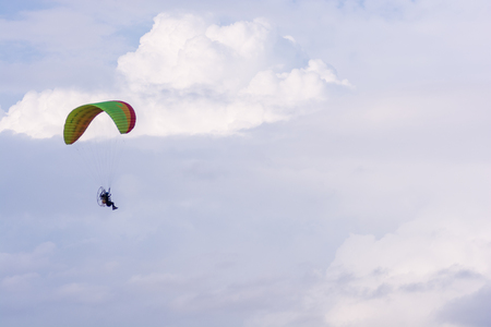 paramotor flying in the air on sky with sunset