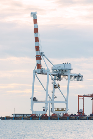 Industrial Container Cargo freight ship with working crane bridgeの写真素材
