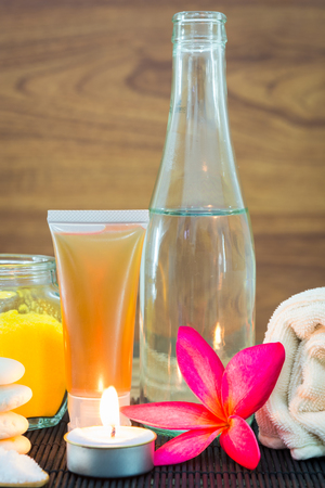 Spa still life with aromatic candles, Frangipani flowers and towel on wooden backgroundの写真素材