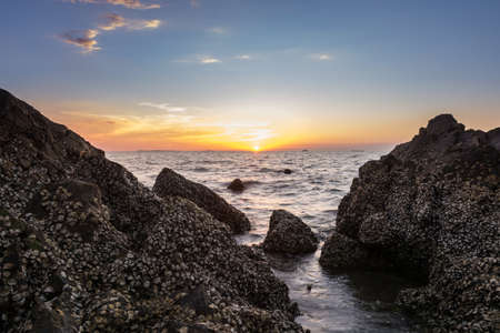 Sunset on the sea with Rocks stoneの写真素材